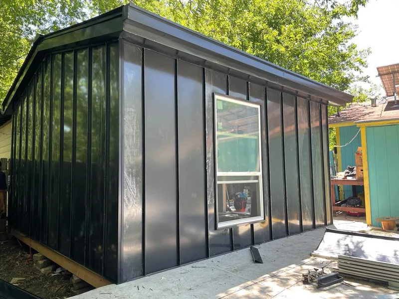 Black standing seam metal wall panels for Roof Inspection in Claremore