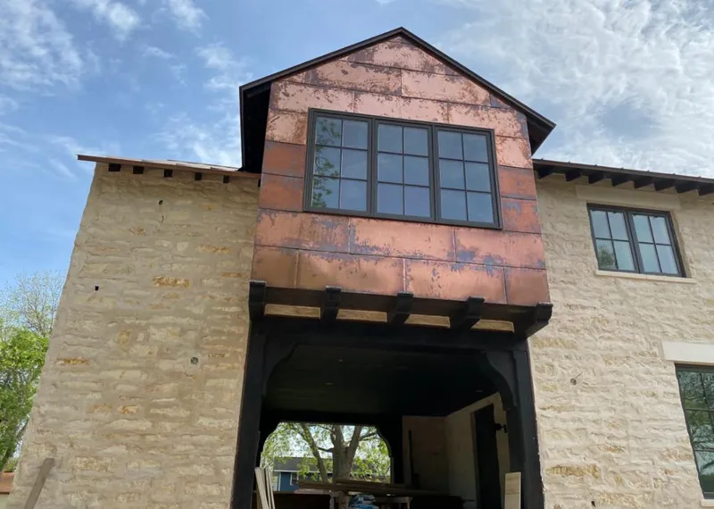 Copper metal panel facade on a stone building for Skylight Installation in Claremore